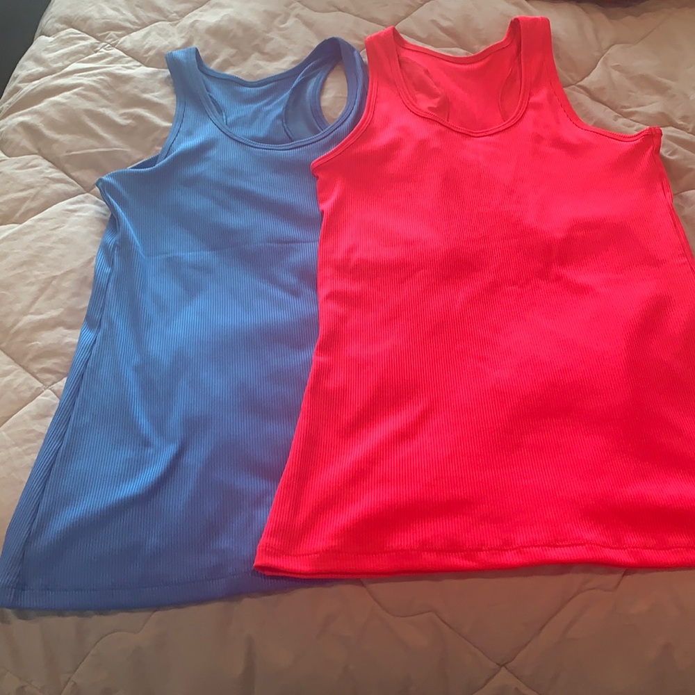 Under armor heat gear tanks. One blue one pink.